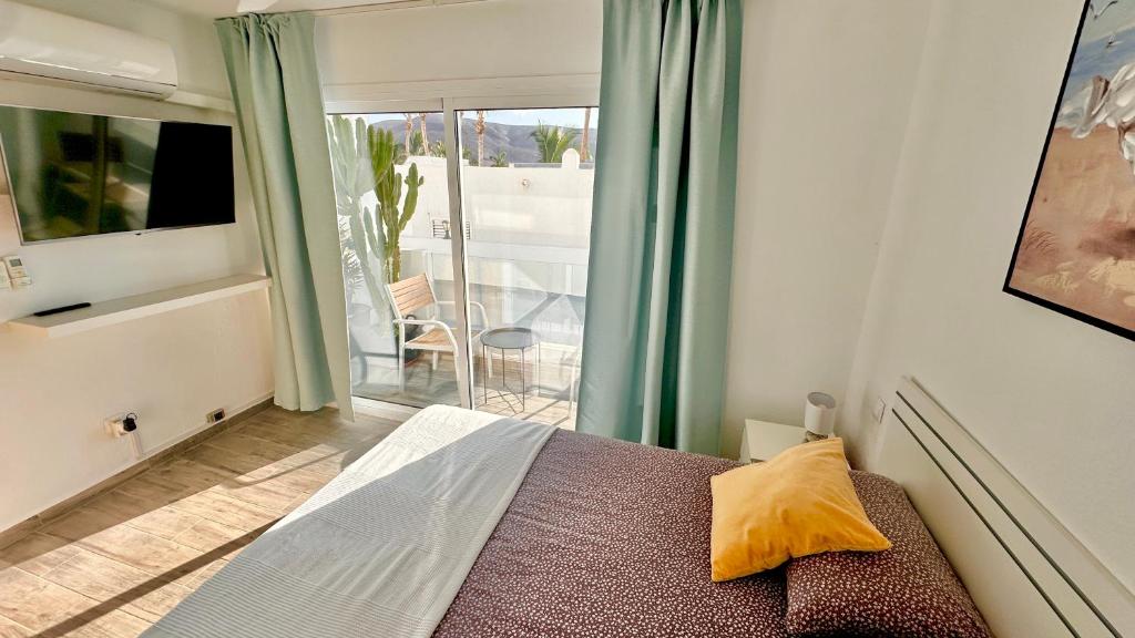 Ένα ή περισσότερα κρεβάτια σε δωμάτιο στο Las Palmeras del Sol