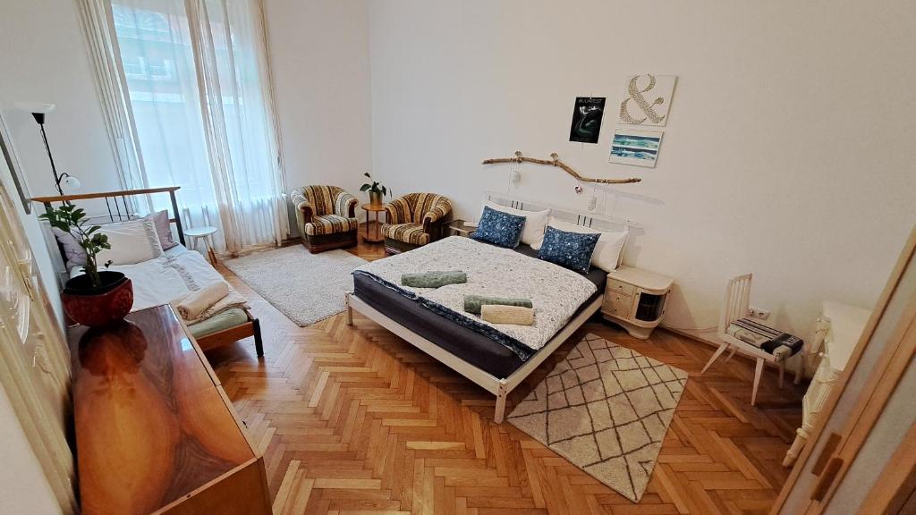 a room with a bed in the middle of it at Gaia Astoria in Budapest