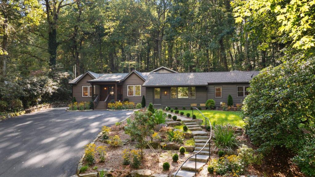 a house with a garden in front of a driveway at Dahlia House, 5 BDRM, Walk to town in Highlands