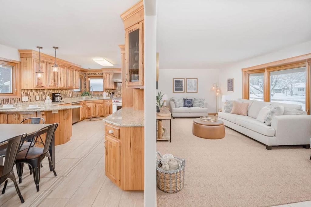 two views of a kitchen and a living room at Stevens Point Getaway - HUGE 5 bedroom Home 3 Full Bath in Stevens Point
