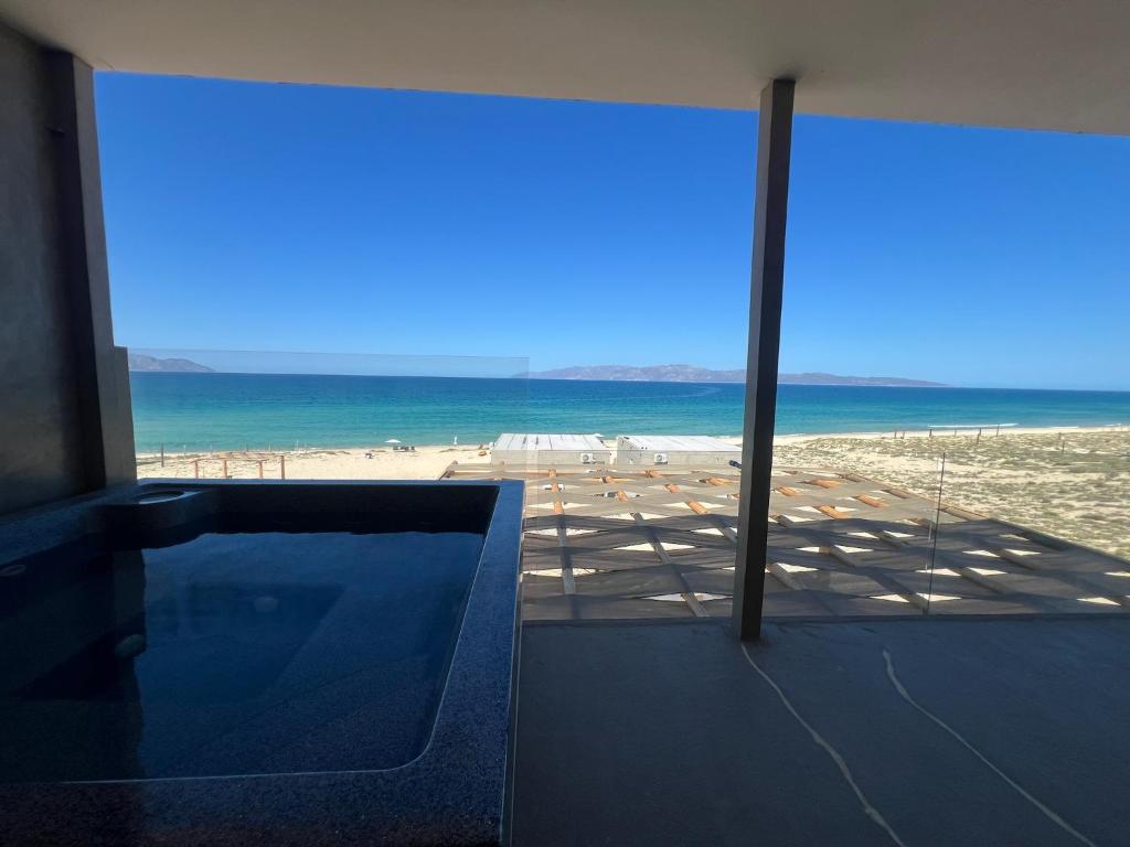 a view of the beach from a room with a window at Private jacuzzi Ocean View Condo in La Ventana