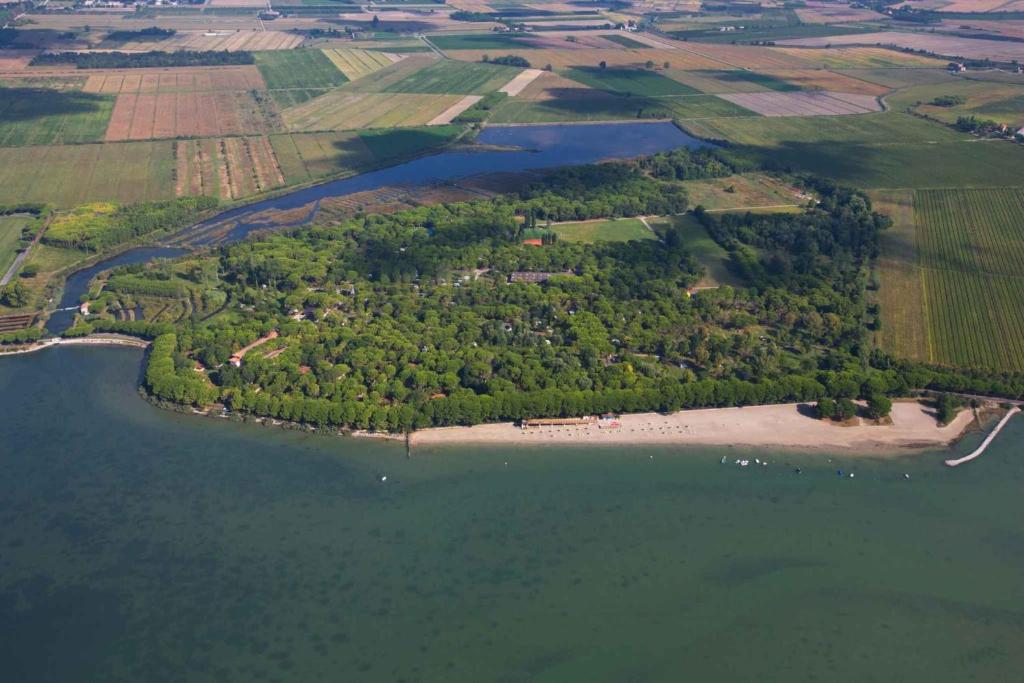 an island in the middle of a body of water at Mobilehome in Belvedere Grado 53452 in Belvedere