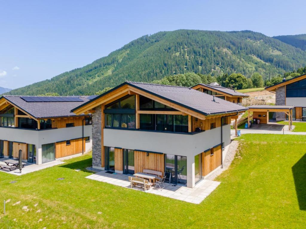an aerial view of a house with mountains in the background at Grebenzen Lodge Prinz in Sankt Lambrecht
