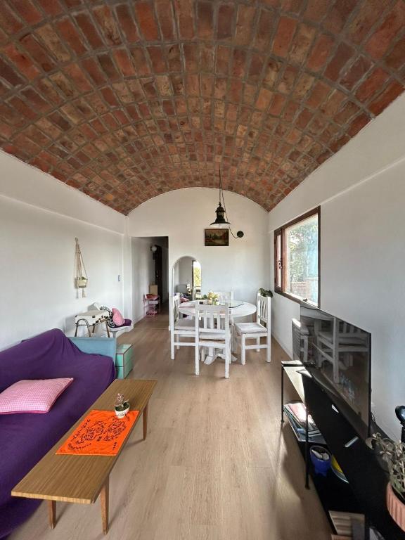 a living room with a couch and a table at aba casa estudio in Pinamar