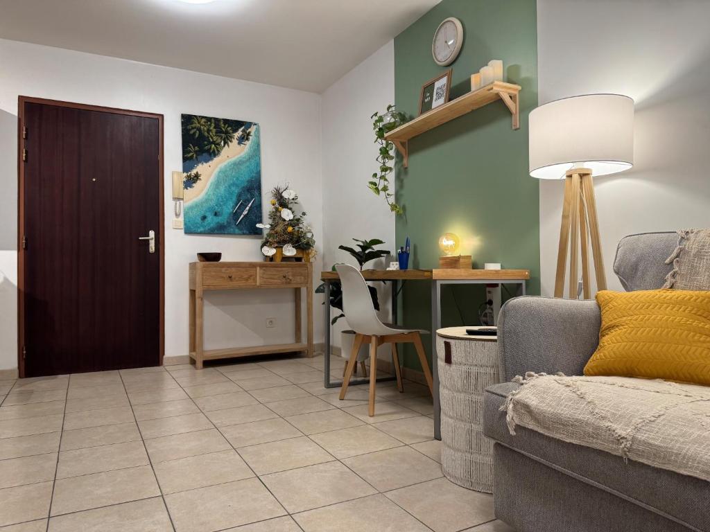 a living room with a couch and a table at Hinahei in Papeete