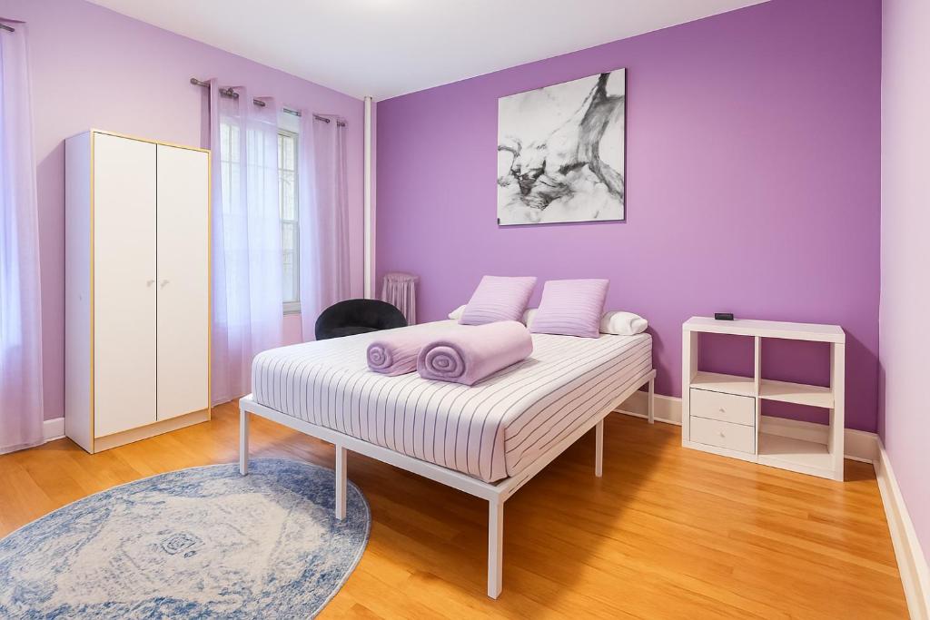 a purple bedroom with a bed with purple walls at Lavender style Room in New York