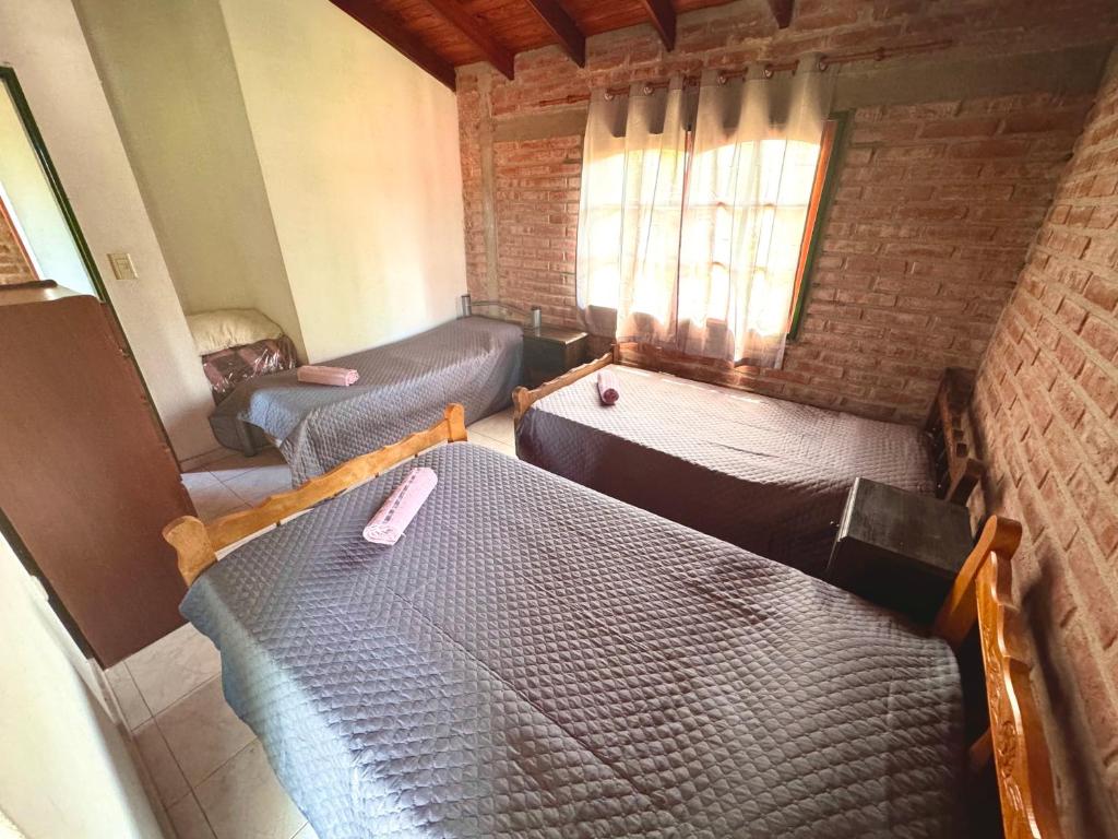 an overhead view of a bedroom with a bed and a couch at Cabaña en el Centro de Mina Clavero in Mina Clavero