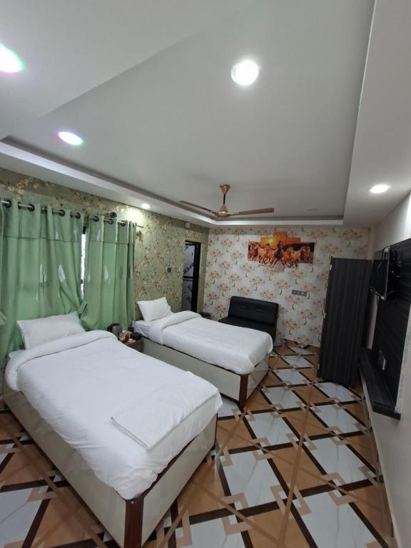 DhangadhiHotel Dev Inn的铺有瓷砖地板的客房内的两张床