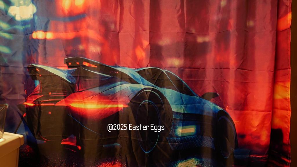a shower curtain with a car on it in a bathroom at Easter Eggs in Rochester