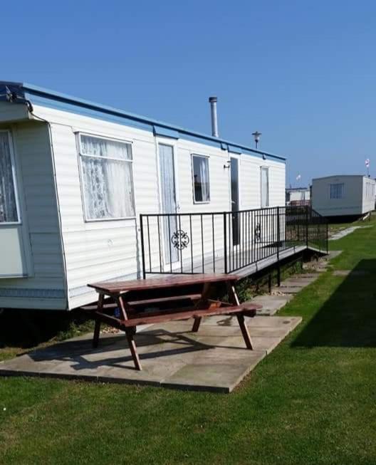a trailer with a picnic table in front of it at Ref G The Chase Caravan Park 3 bed 8 berth in Ingoldmells