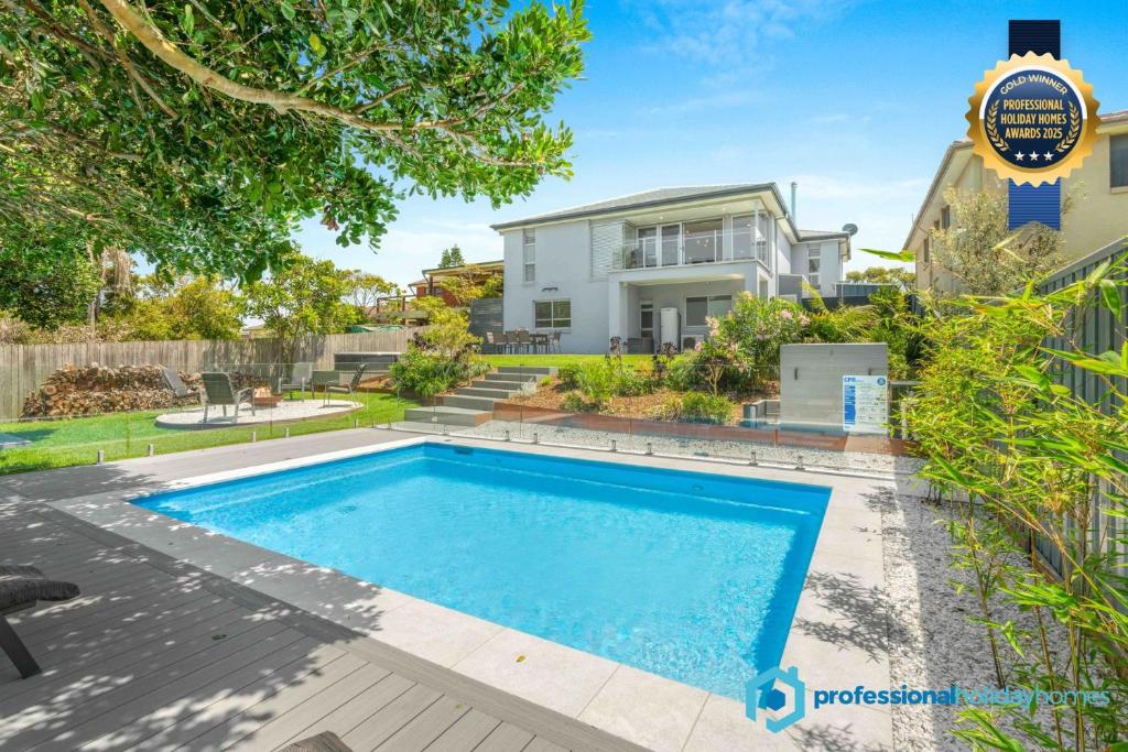 an image of a swimming pool in front of a house at Sea La Vie - Pet Friendly with Fireplace and Swimming Pool & Spa in Culburra Beach