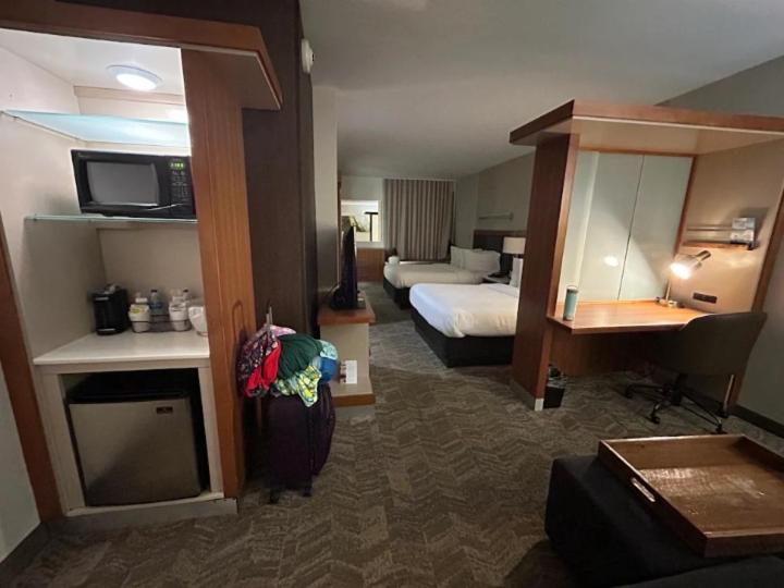 a hotel room with two beds and a living room at Springhill suites by Marriott in Macon