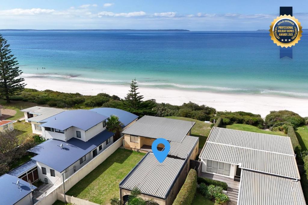 an aerial view of a house and the ocean at Quay's Cabin - Absolute Beachfront with Views in Callala Beach