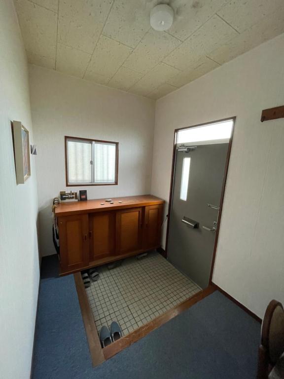 a room with a bathroom with a desk and a door at kumanonisumu! in Kumano
