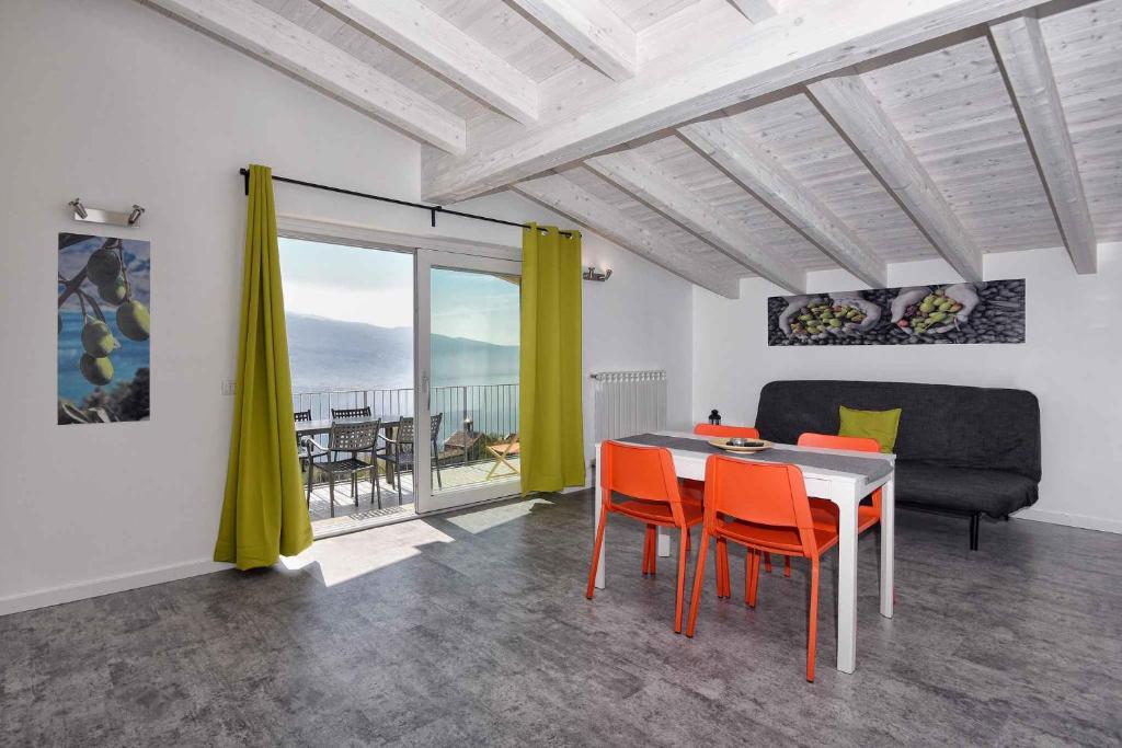 a living room with a table and chairs and a couch at Apartments in Tremosine sul Garda 34645 in Tremosine Sul Garda