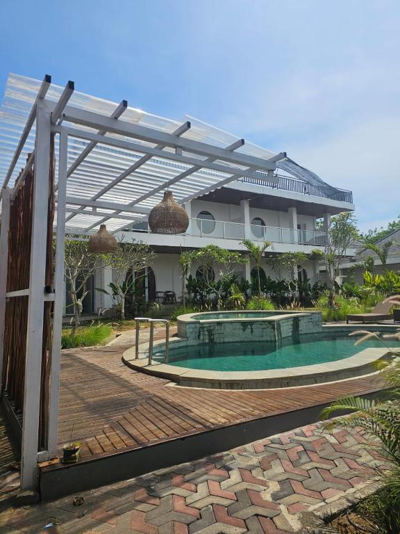 a swimming pool in front of a building at BBC Suites and Garden in Uluwatu