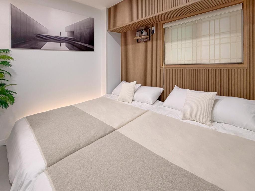 een groot wit bed in een kamer met een raam bij 서울 stay moon 종로 혜화 경복궁 SKKU 명동 DDP 광장시장 인사동 낙산공원 KPDH in Seoul
