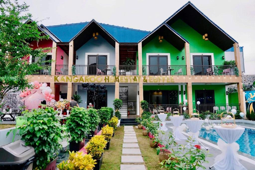 a house with a garden and a swimming pool at Kangaroo homestay in Cat Ba