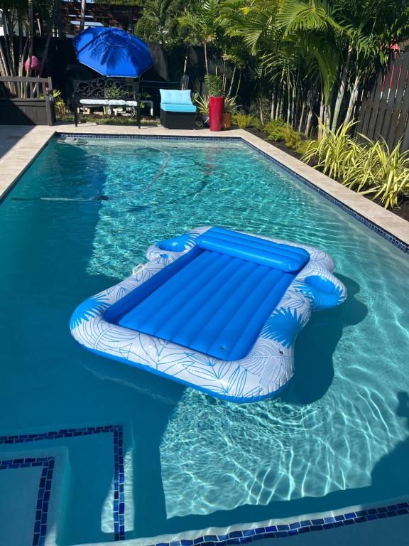 a blue inflatable raft in a swimming pool at POOLSIDE MANOR - Men Only Clothing-Optional in Fort Lauderdale