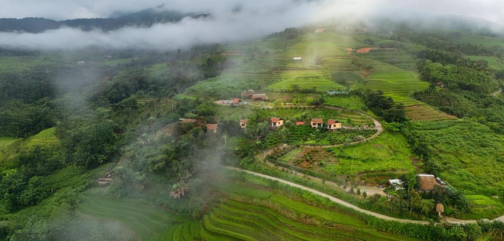 an aerial view of a village on a mountain at SIM Farmstay in Ha Giang