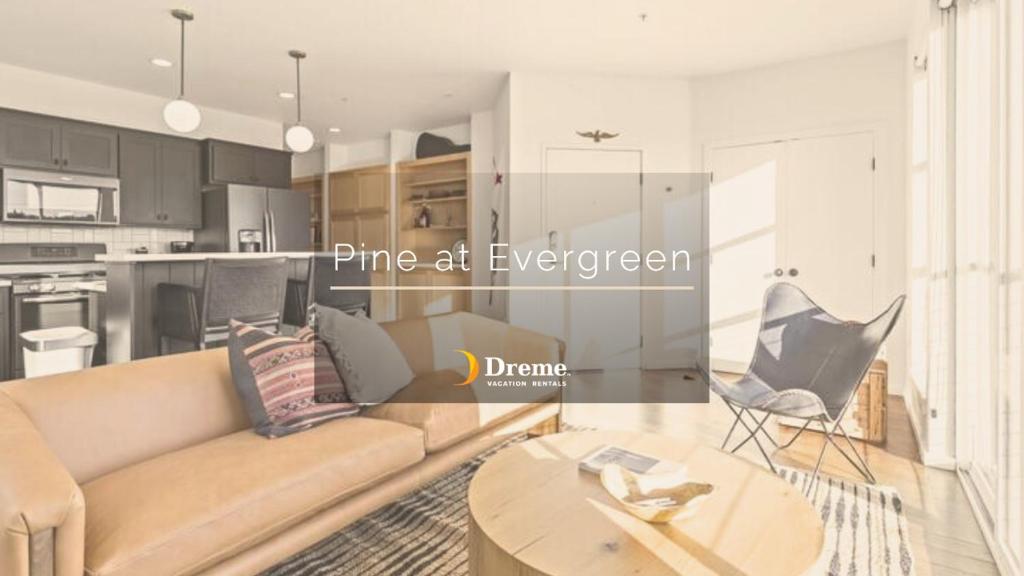 a living room with a couch and a table at Pine at Evergreen - Boutique Hotel in Redding