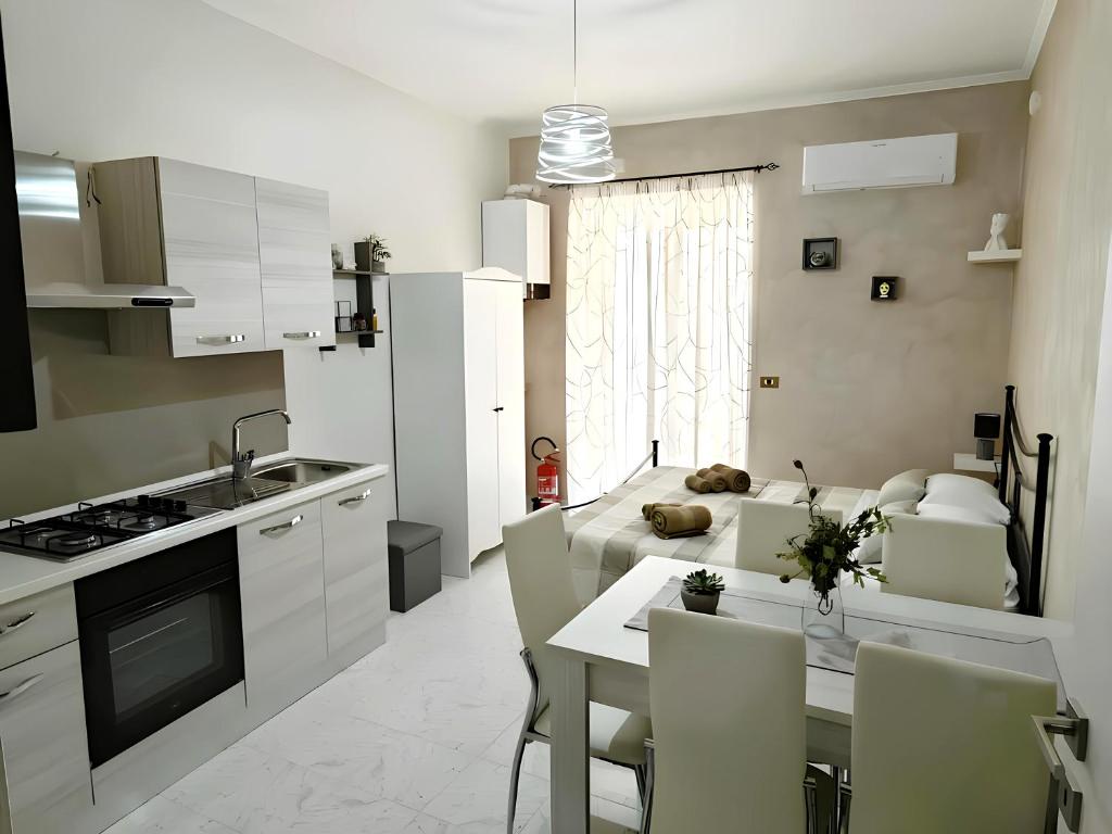 a kitchen and living room with a table and chairs at Da Nonno Mario in Bagnoli Irpino