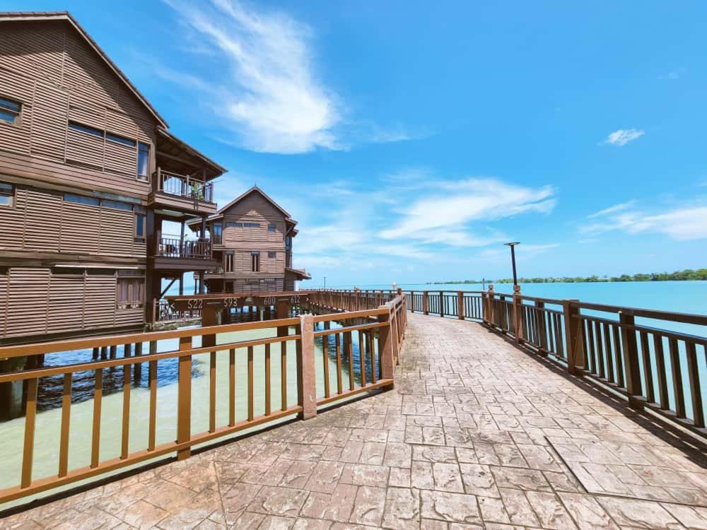 a boardwalk leading to a house and the water at Sea Villa Langkawi in Kampung Padang Masirat