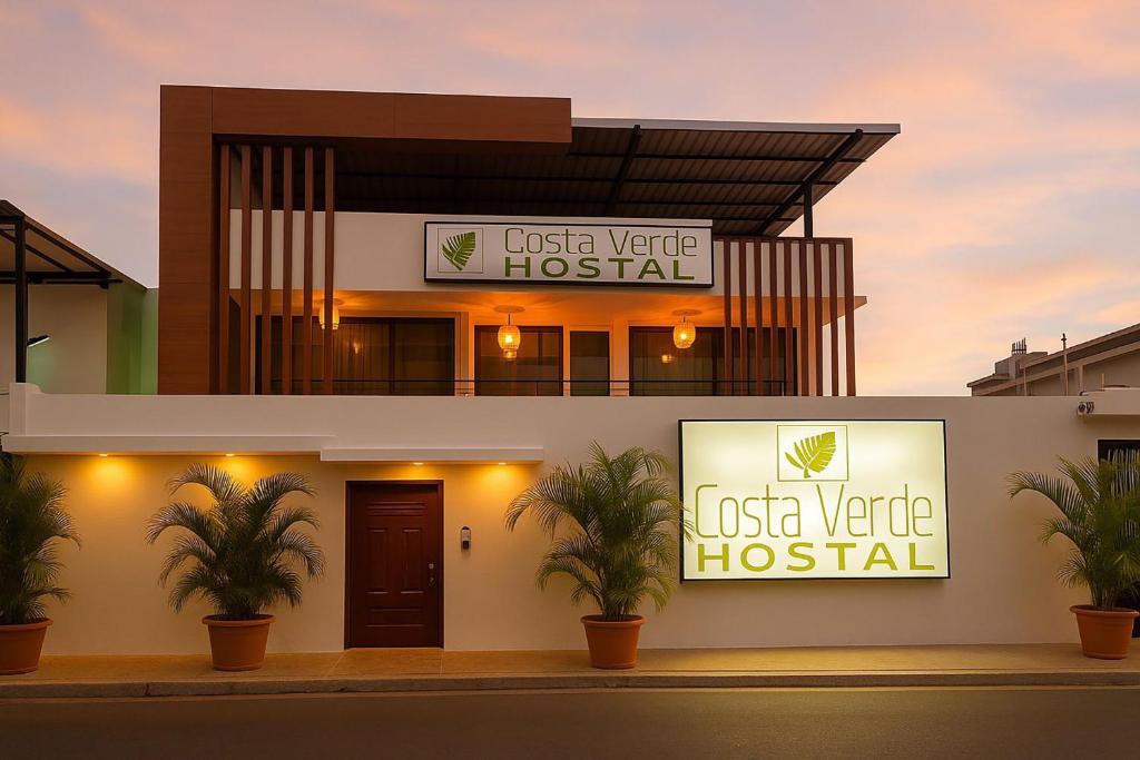 a hospital with two signs on the side of a building at Costa Verde Hostal in Manta