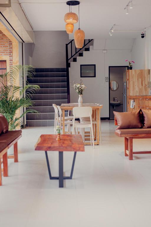 a living room with a table and chairs at Ark Pai in Pai
