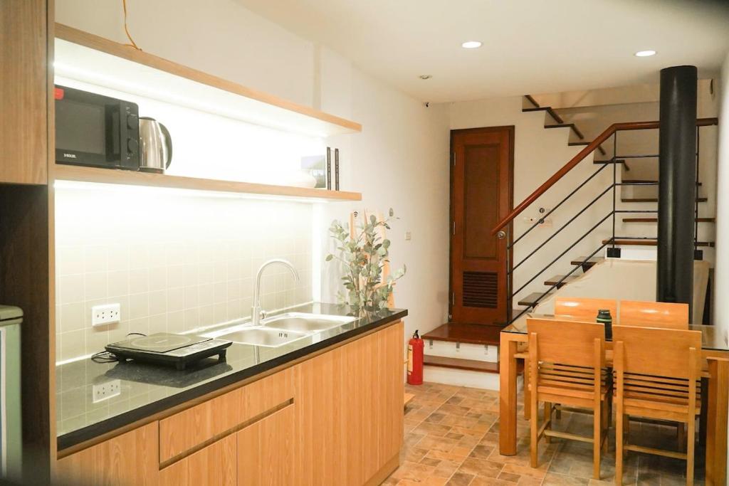 a kitchen with a sink and a kitchen with a staircase at Whole House with 3 Bedrooms in Hoan Kiem - 7mins to Hoan Kiem lake - FREE launchdry & breakfast in Hanoi