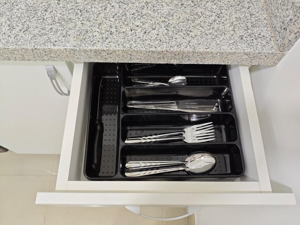 a drawer filled with utensils in a kitchen counter at Habitacion con entrada independiente y aire acondicionado, Centro Piura in Piura