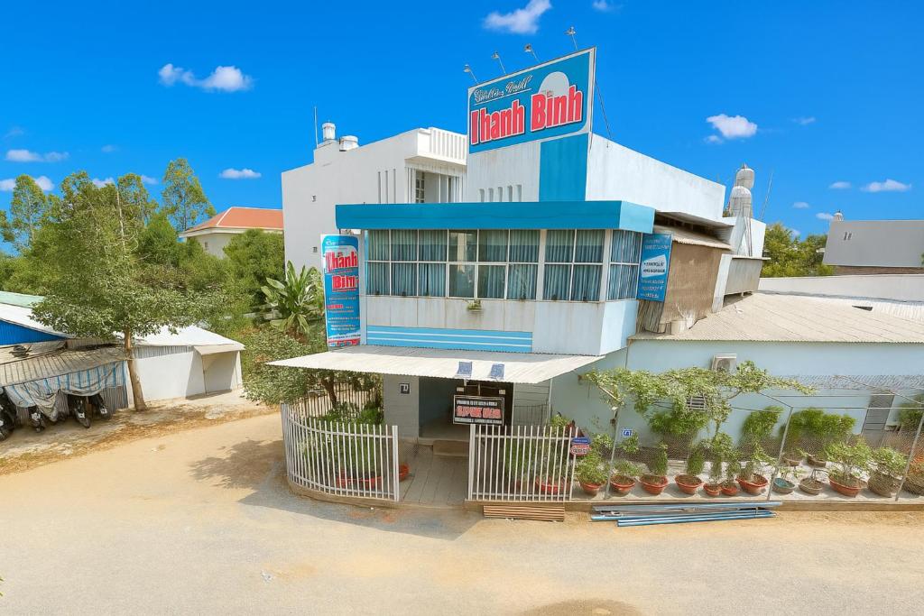 a building with a sign on top of it at Thanh Bình Hostel in Can Tho