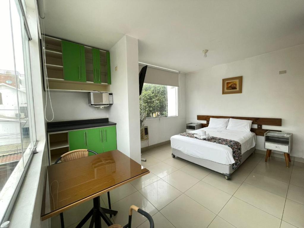 a bedroom with a bed and a table in it at Golden Suite Miraflores 