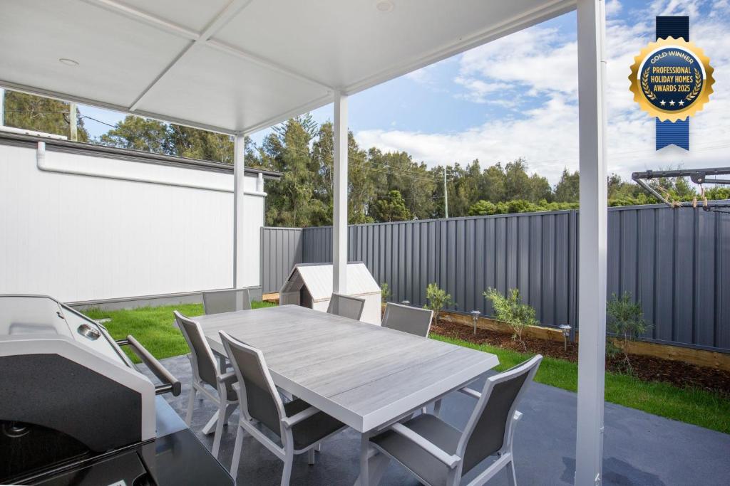 a white tent with a table and chairs at Saoire - Pet Friendly - 5 Mins Walk to Beach in Culburra Beach