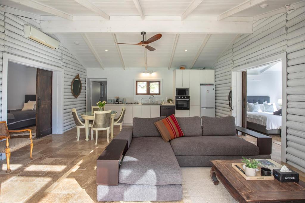 a living room with a couch and a table at Webbs Creek Farm Retreat in Wisemans Ferry