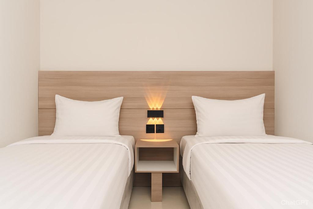 Ένα ή περισσότερα κρεβάτια σε δωμάτιο στο INARA By Kiyana