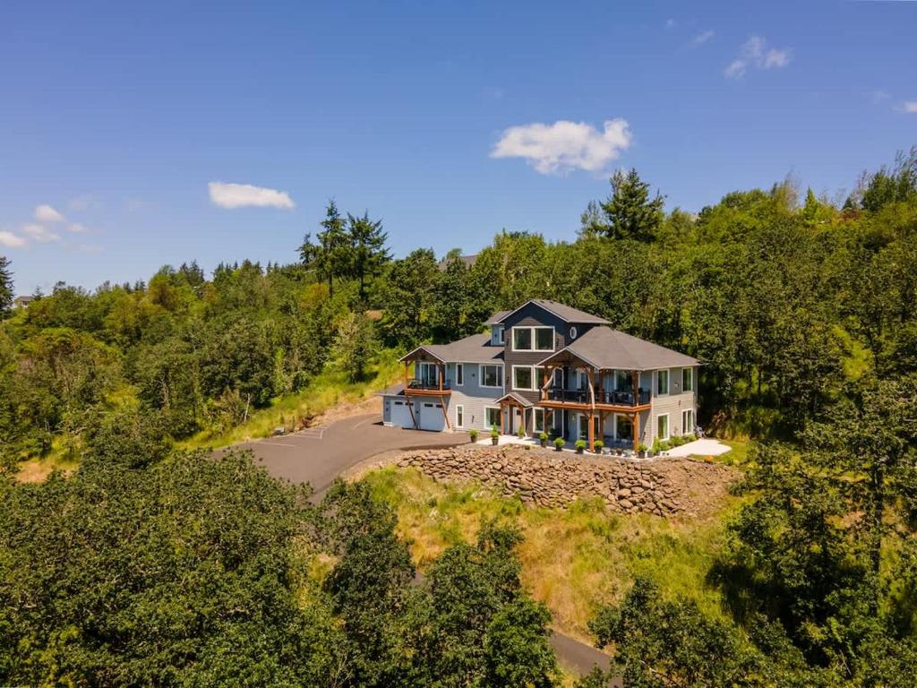 an aerial view of a house in the woods at Panoramic River Views - Nature Framed in Every Window in Kelso