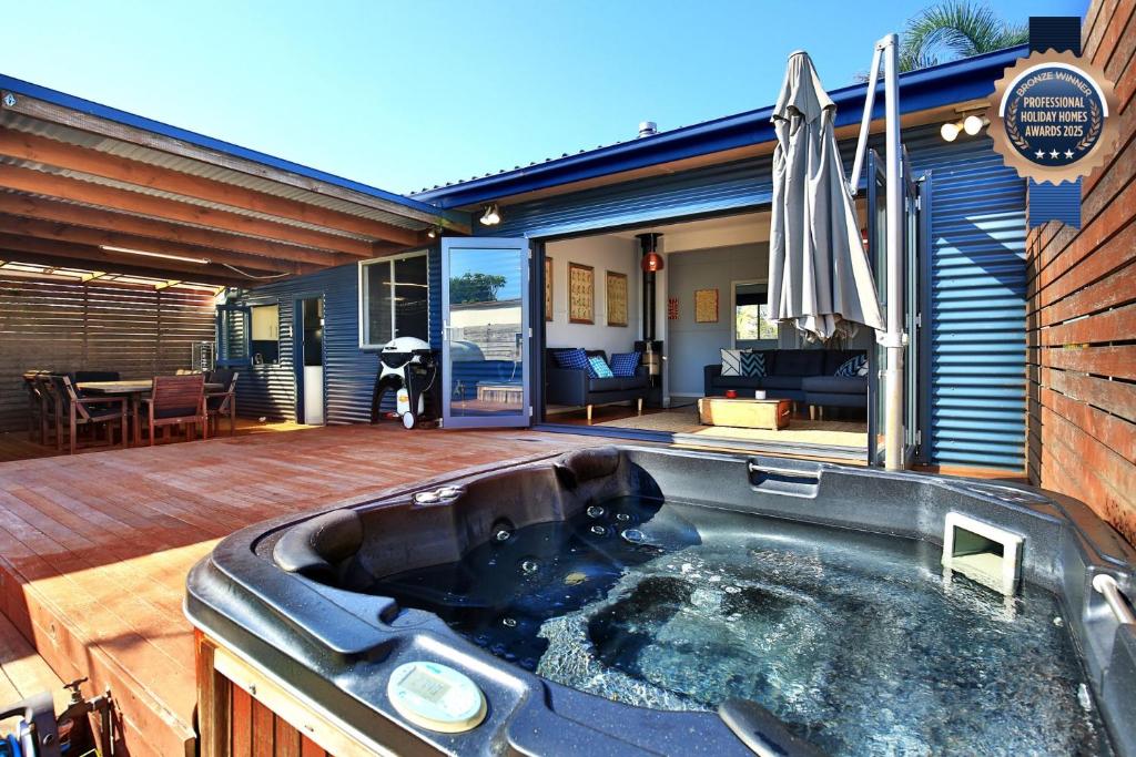 a hot tub on the deck of a house at Bluetongue at Culburra I Pet Friendly 4 Mins to Beach in Culburra Beach