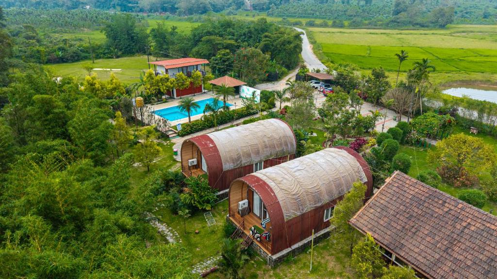 an overhead view of a house with a pool at Streamedge Sakleshpur in Hanbalu