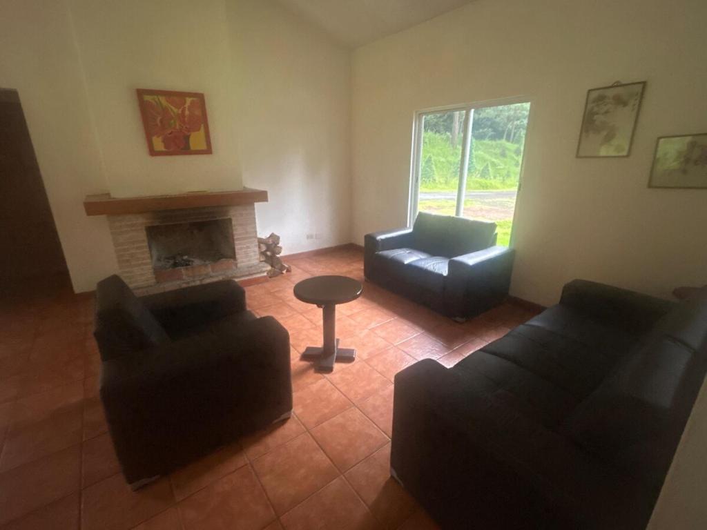 a living room with two couches and a fireplace at Casa Nueva Holanda in Las Vigas
