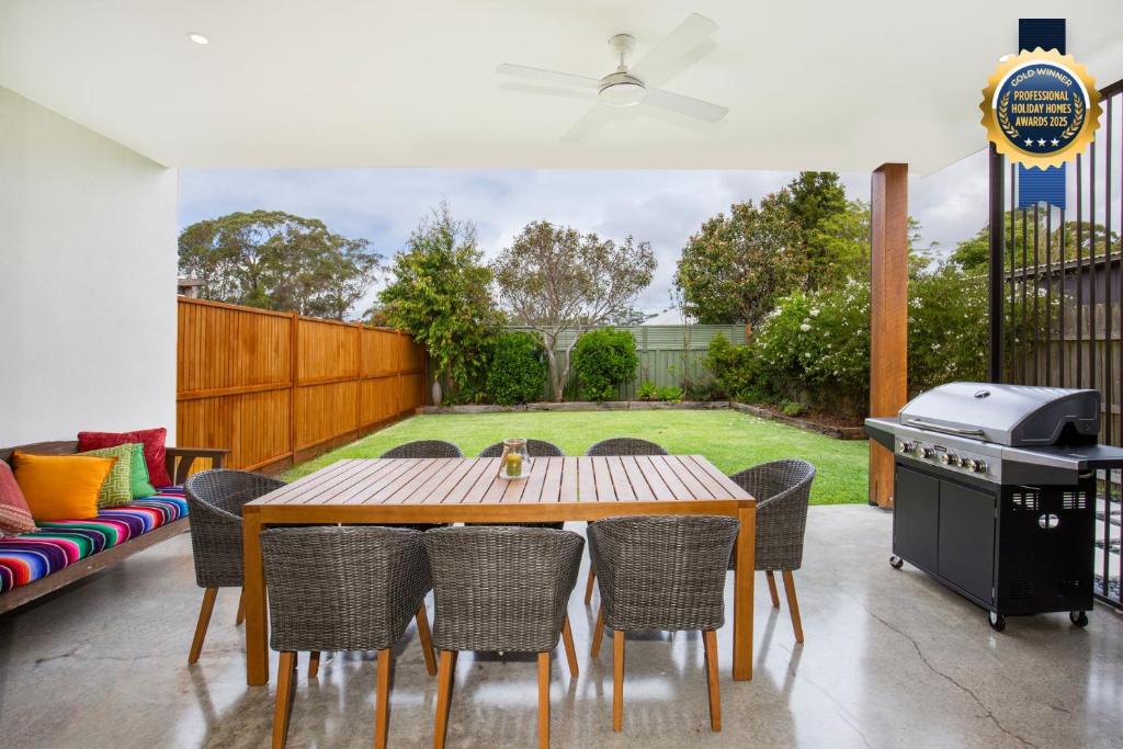 a patio with a table and chairs and a grill at Keppel - Pet Friendly - 4 Mins Walk to Beach in Huskisson