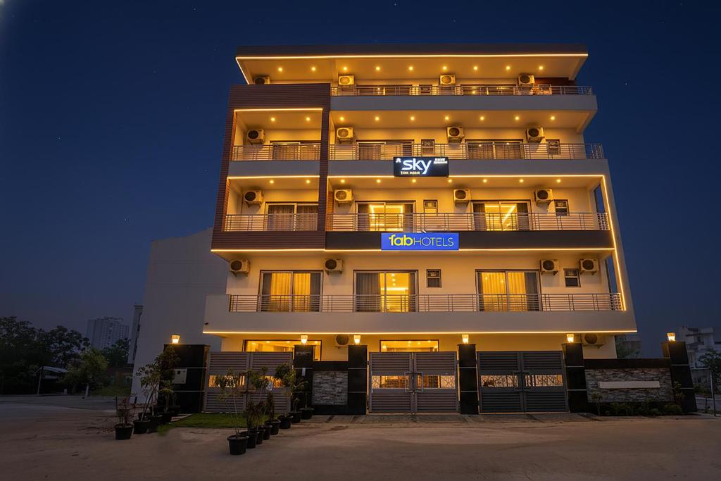 a tall building with a sign on it at night at FabHotel Sky - Nr Sapphire 83 Mall, Manesar in Gurgaon