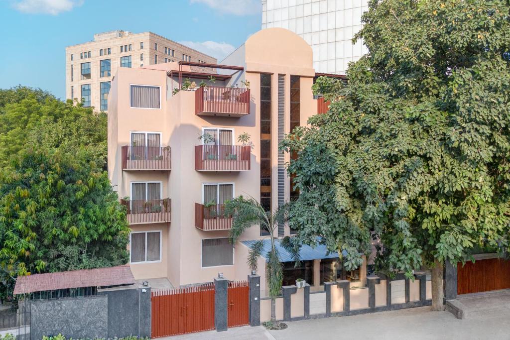 an apartment building with balconies and a tree at Nook By Zipcode in Gurgaon
