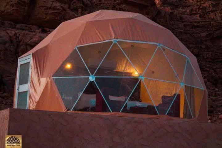 a large tent with a window on top of a wall at Wadi Rum in Al Jafr