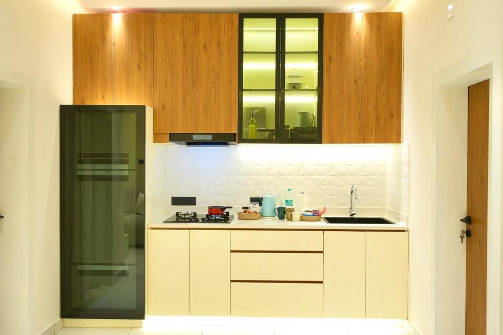 a kitchen with a sink and a counter top at Royale Suites - 3 BHK Serviced Apartment in Kadayirippu