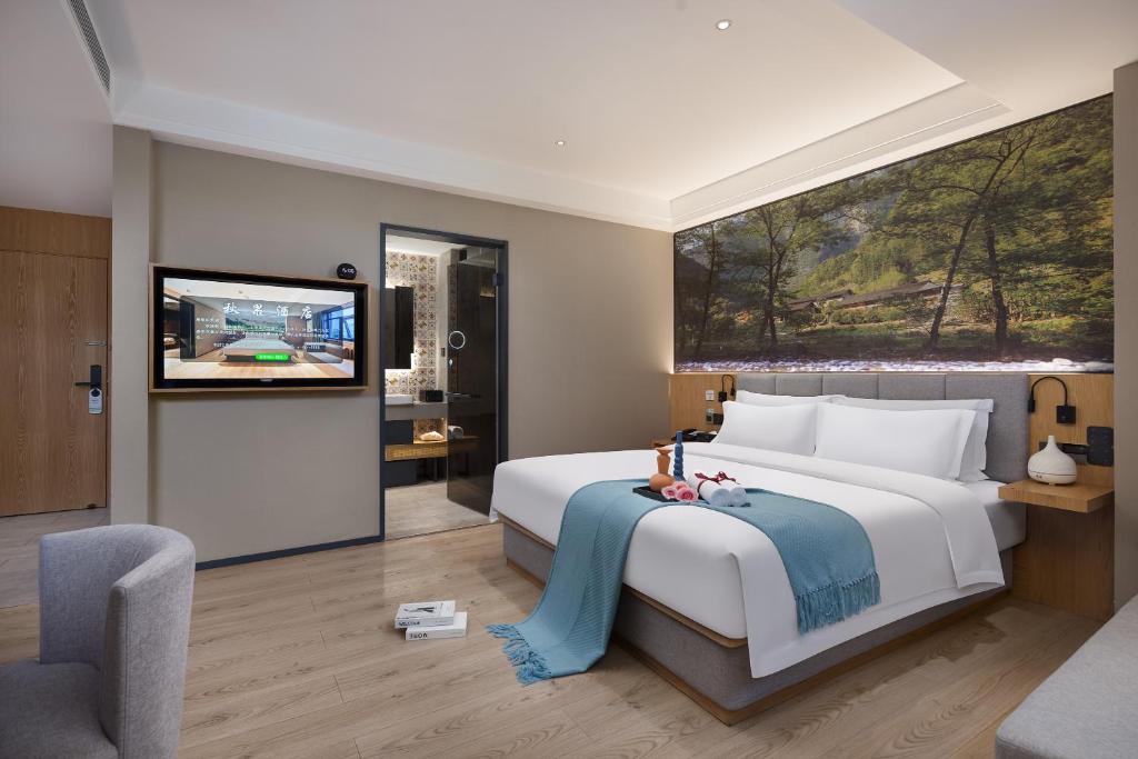 Ένα ή περισσότερα κρεβάτια σε δωμάτιο στο 秋果酒店西安钟楼北大街地铁站店