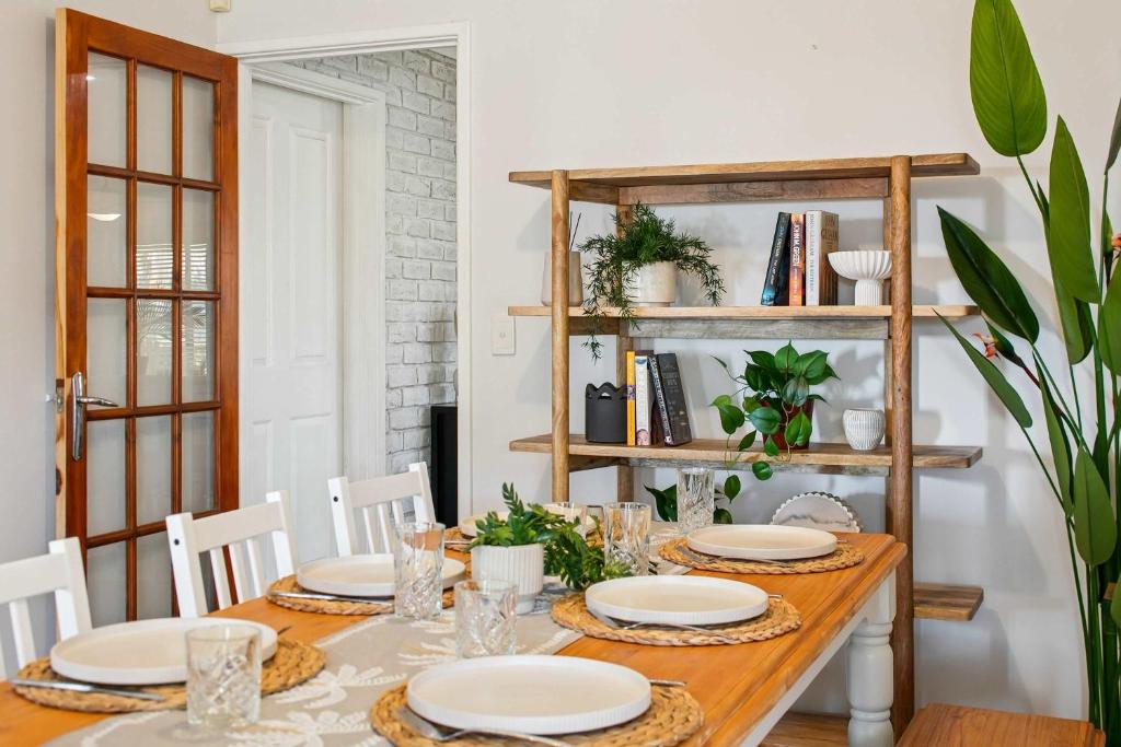 a dining room with a table with plates on it at Seaview Escape Ocean Views & 500MBs Wifi in Perth