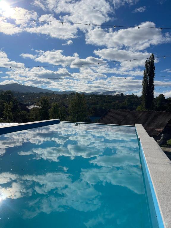a swimming pool with a view of the sky at Domeniul Bondarelului in Ocolişu Mic