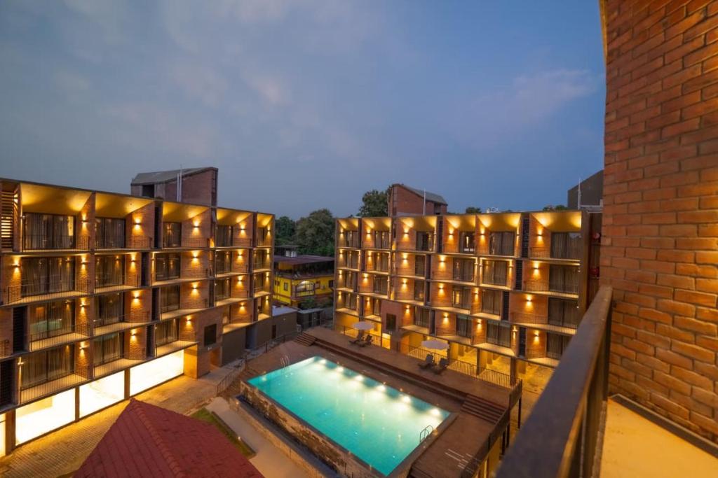 a hotel with a swimming pool and a building at SinQ Village in Bambolim