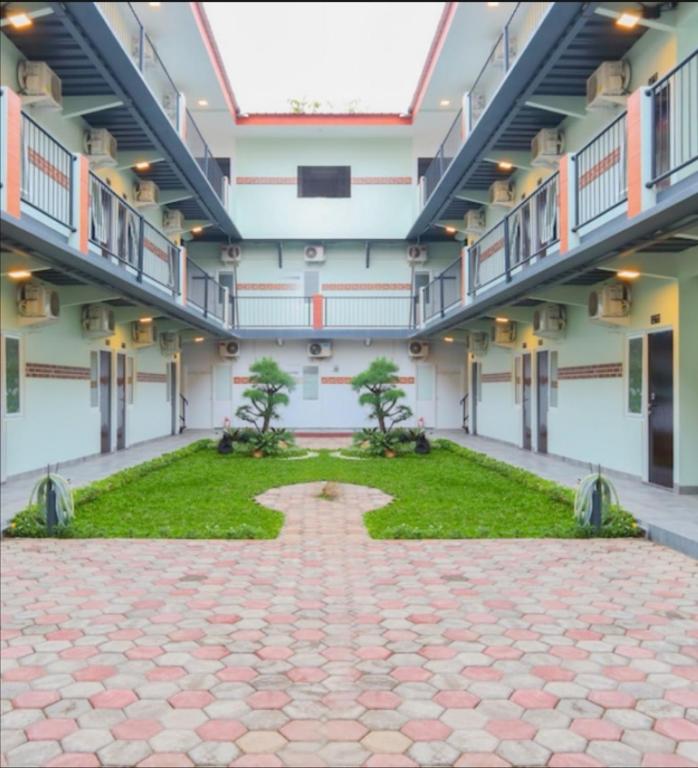 an empty building with a courtyard with trees in it at Puspiptek Residence Syariah in Curug 3